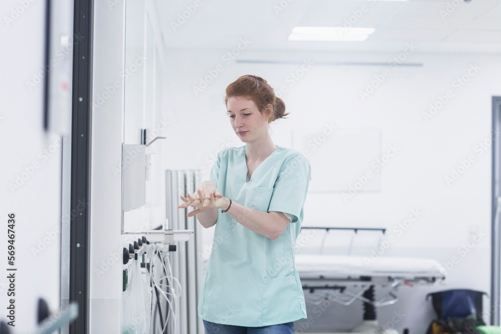 Hospital nurse disinfecting hands at hospital Hospital nurse disinfecting hands at hospital