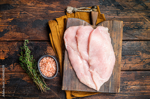 Papier peint Fresh Raw chicken cutlet breast fillets on a wooden board, fowl meat