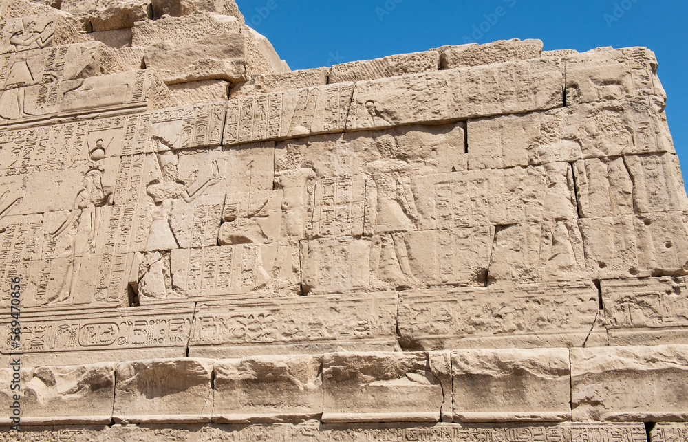 Ancient egyptian temple wall with hieroglyphic carvings