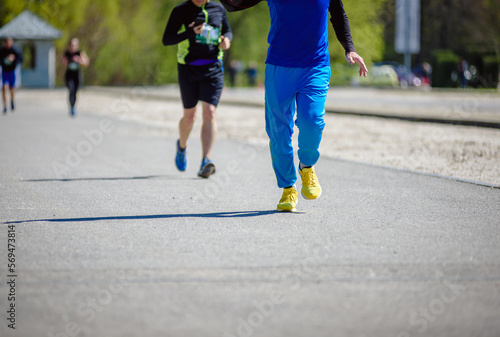 Fototapeta Naklejka Na Ścianę i Meble -  Group of runners with colorful shoes taking part in amateur marathon