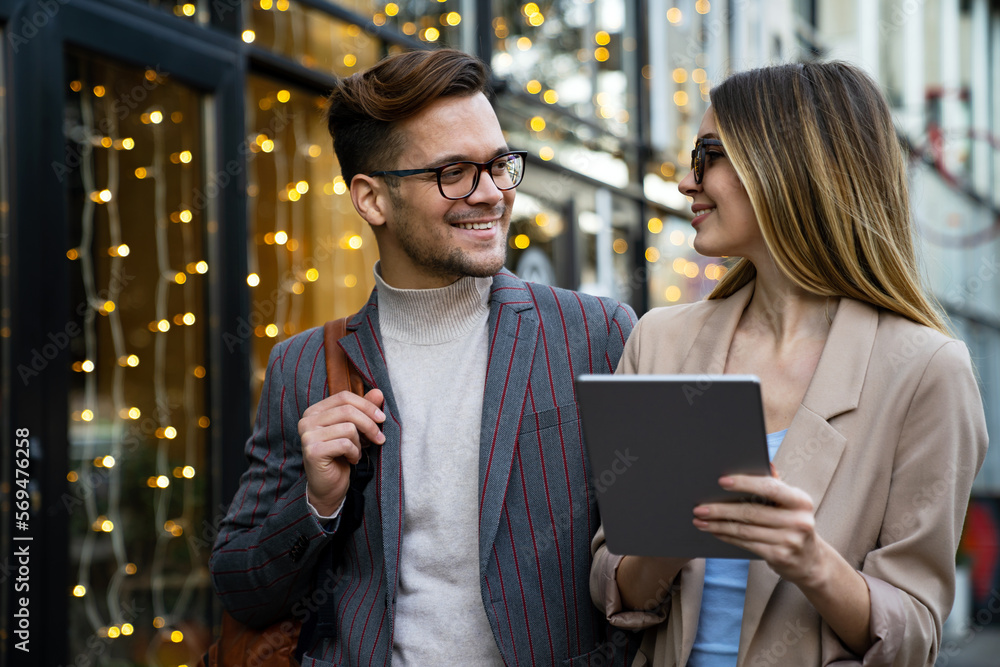 Two creative business people working on social media strategy using a digital tablet Two creative business people working on social media strategy using a digital tablet