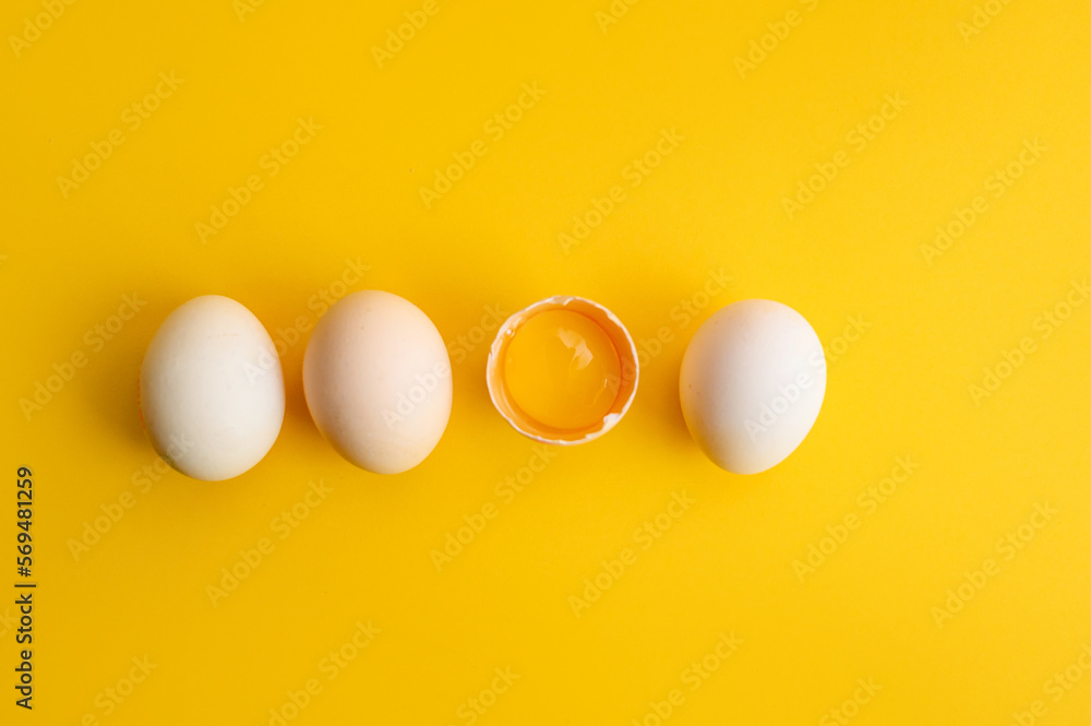 Raw chicken eggs on a colored background, top view. eggs on a yellow background. Place for text Raw chicken eggs on a colored background, top view. eggs on a yellow background. Place for text