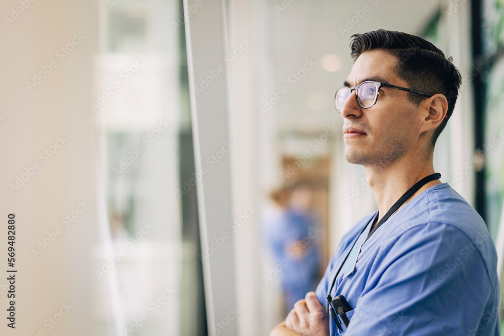 Mature male healthcare staff contemplating at hospital Mature male healthcare staff contemplating at hospital