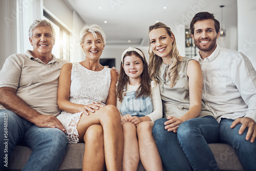 Portrait  generations and family on sofa  smile and relax on break  bonding together and in living room. Face  grandparents and mother with father  daughter and on couch for quality time or happiness