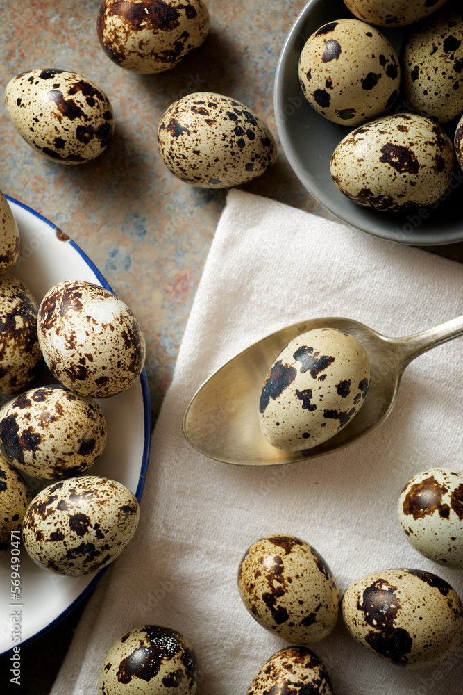 Fototapeta premium Quail eggs on a stone table.