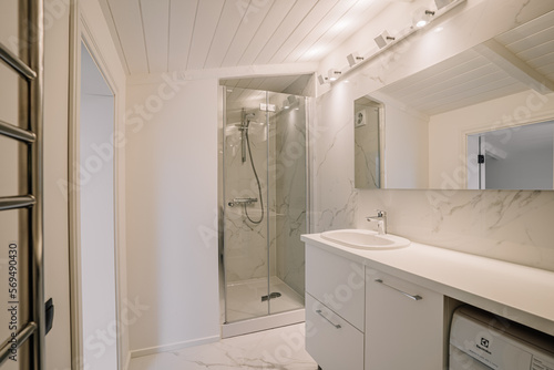 Interior of white bathroom with bathtub and toiletries