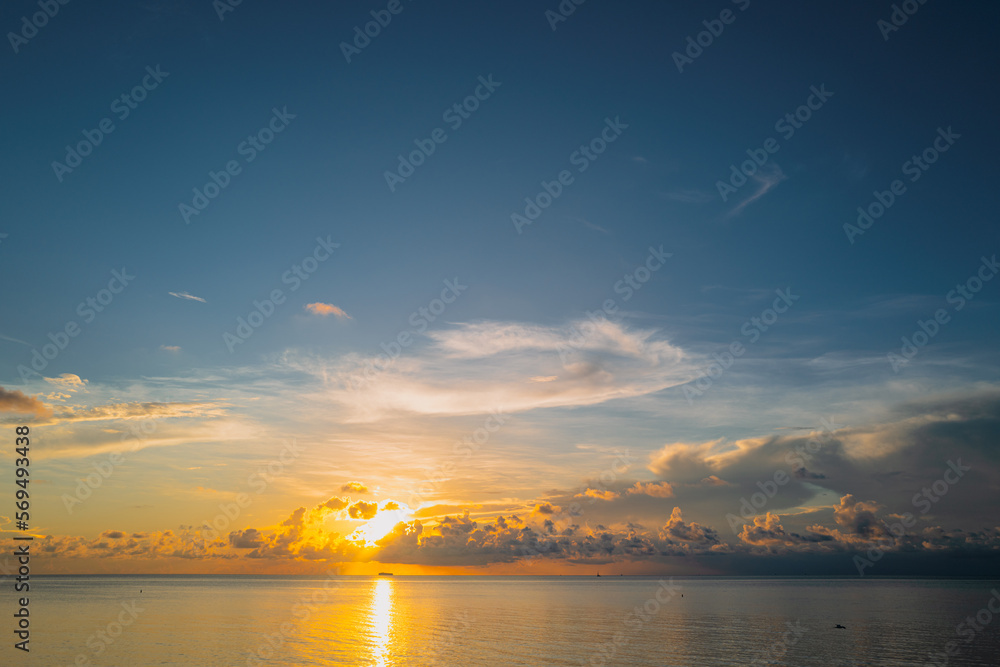 Naklejka premium Sunrise sea on tropical beach. Landscape of beautiful beach. Beautiful sunset at sea. Seascape in summer morning. Ocean sunset on sky background with colorful clouds.