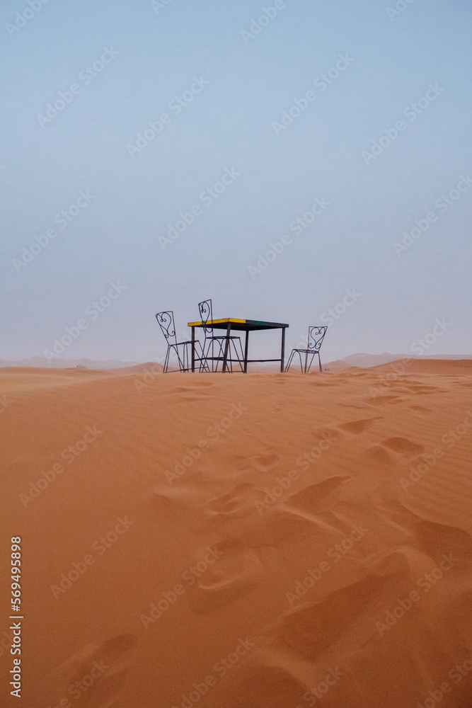 Set of a table and chairs in the middle of the desert in Merzouga, Morocco