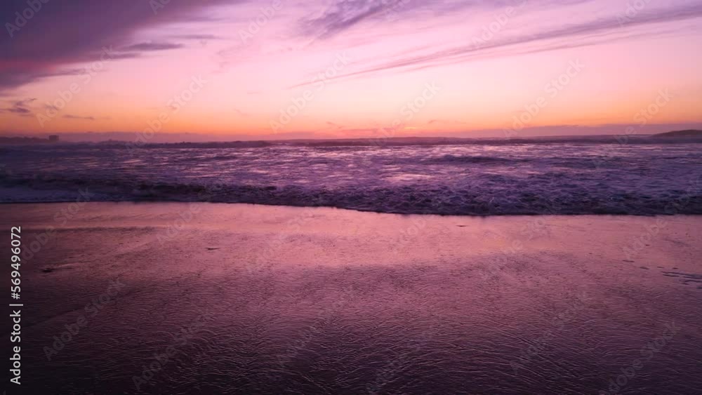 pink ocean waves roll in at sunset pink ocean waves roll in at sunset
