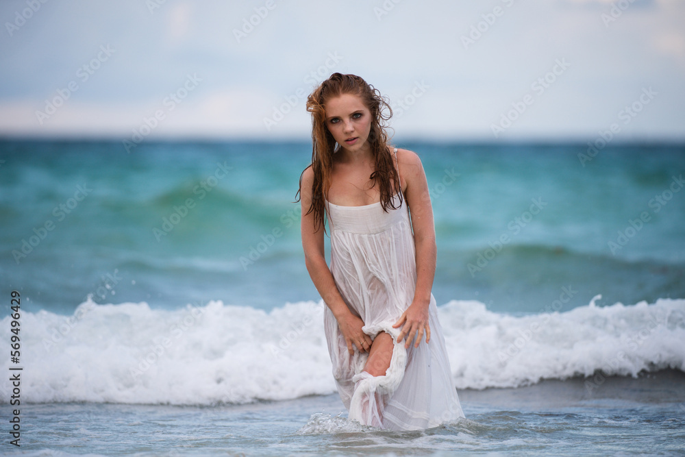 Young attractive girl with perfect body on the tropical summer beach. Sexy woman on sea, sensual female model posing near ocean background with copy space. Young attractive girl with perfect body on the tropical summer beach. Sexy woman on sea, sensual female model posing near ocean background with copy space.