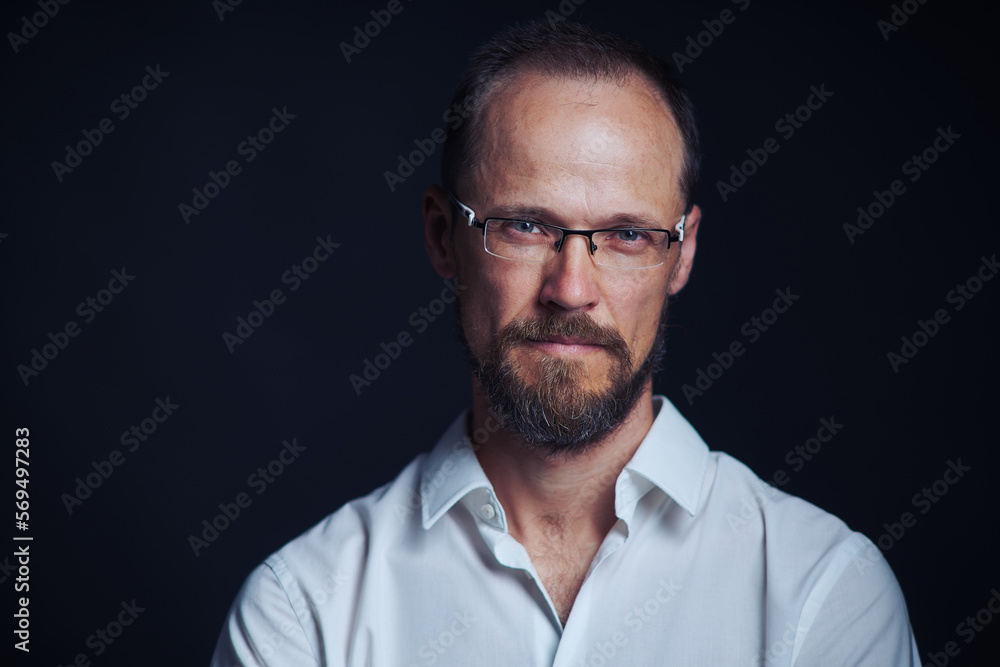 Concentraited middle age man in white shirt and eyeglasses looking squinting at camera
