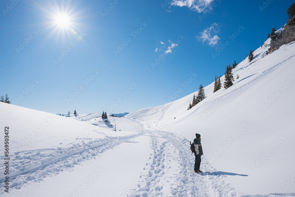 hiker at mountain trail Rofan alps in winter, austrian landscape