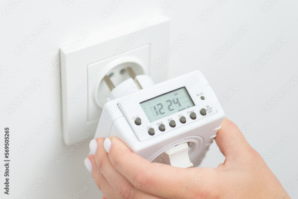 Plugin outlet timer-computer to the socket. Controlling usage of electricity of electronic devices by smart outlet adapter Plugin outlet timer-computer to the socket. Controlling usage of electricity of electronic devices by smart outlet adapter