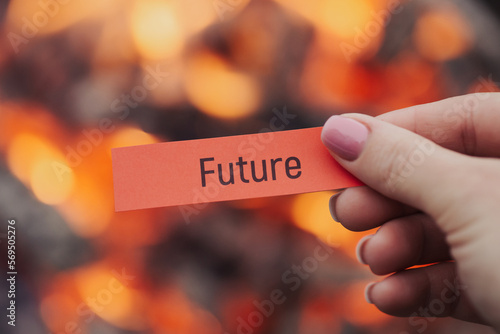 Hand of a woman holding red sheet of paper with word 