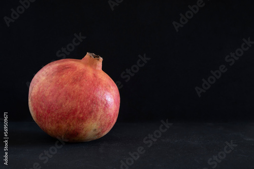 red big pomegranate on dark background