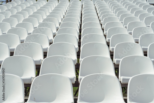 Seats of tribune on sport stadium. Concept of fans, chairs for audience, cultural environment concept. mpty seats, modern stadium.