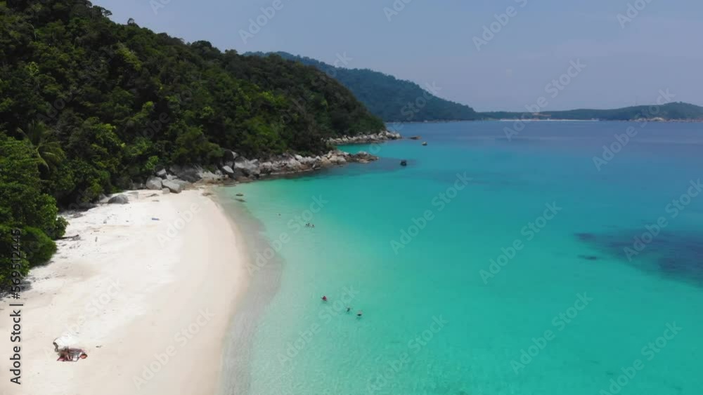 Aerial view of turquoise seashore surrounded by tropical mountains Aerial view of turquoise seashore surrounded by tropical mountains