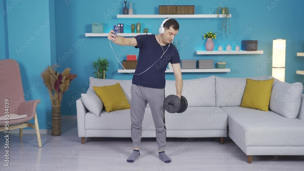 Man filming himself pretending to exercise and sitting down after the video ends. Man filming himself pretending to exercise and sitting down after the video ends.