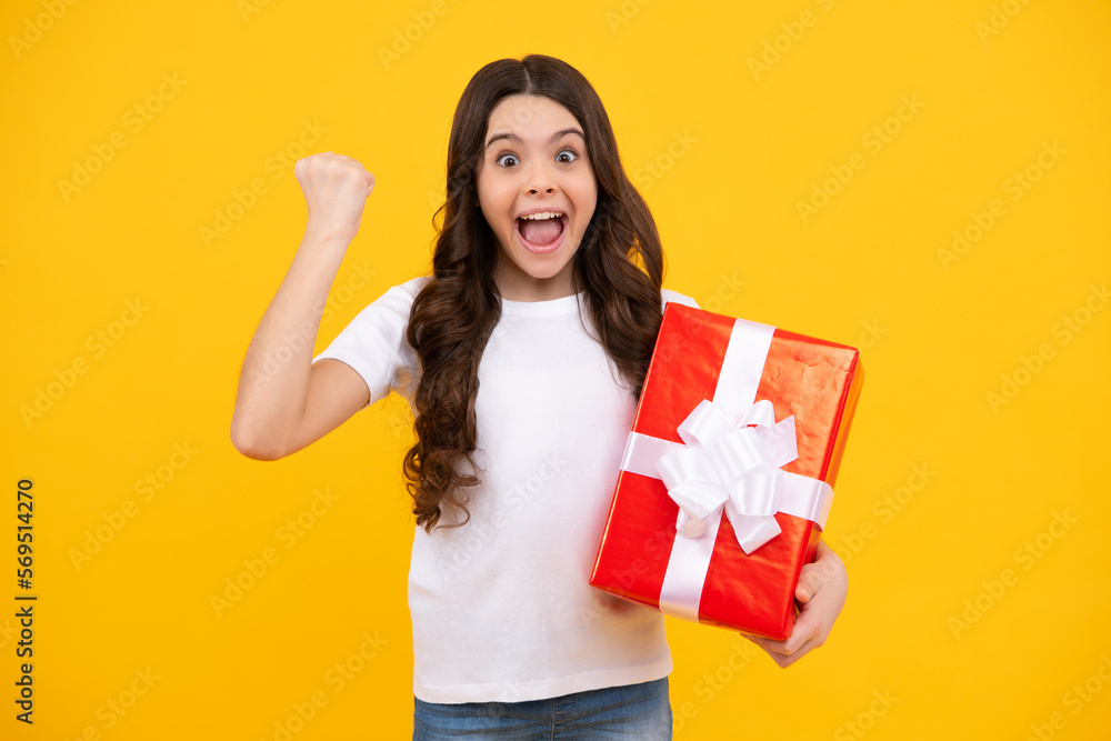 Amazed teenager. Portrait of teenager child girl 12, 13, 14, years old holding Christmas gift box. Teen giving birthday gift. Excited teen girl. Amazed teenager. Portrait of teenager child girl 12, 13, 14, years old holding Christmas gift box. Teen giving birthday gift. Excited teen girl.