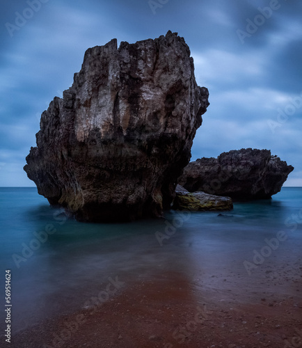 rock in the ocean in the evening