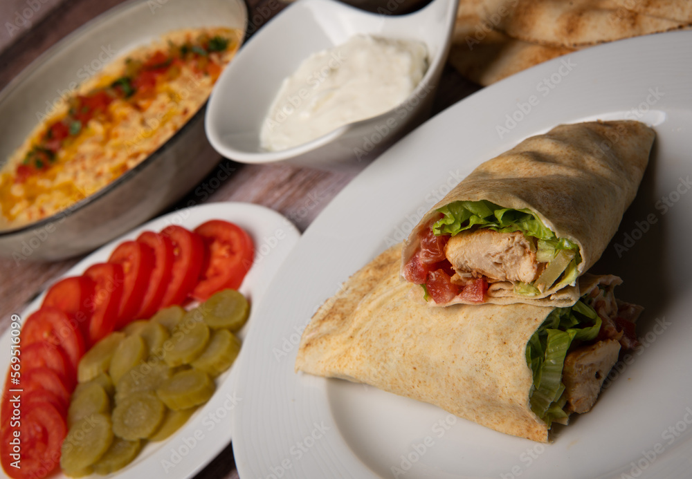 Lebanese recipe of chich taouk, garlic cream, toum, in a Lebanese bread, tabbouleh and chickpea puree, hummus High quality photo Lebanese recipe of chich taouk, garlic cream, toum, in a Lebanese bread, tabbouleh and chickpea puree, hummus High quality photo