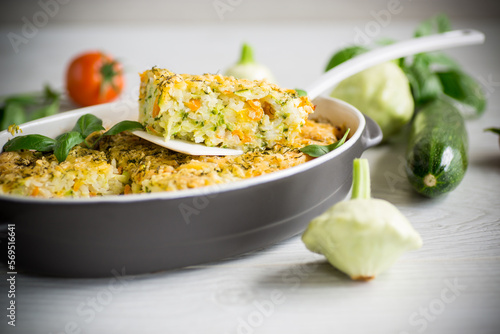 vegetable casserole of patissons, zucchini, carrots in a ceramic form .