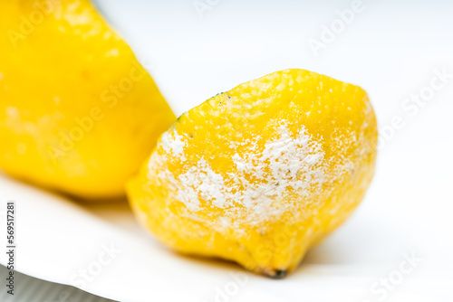Macro close up of rotten zest with fungi and white mold on lemon  photo