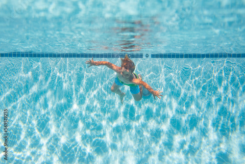Kid boy swim underwater in sea. Kid swimming in pool under water. Active kid swimming, playing and diving, children water sport.