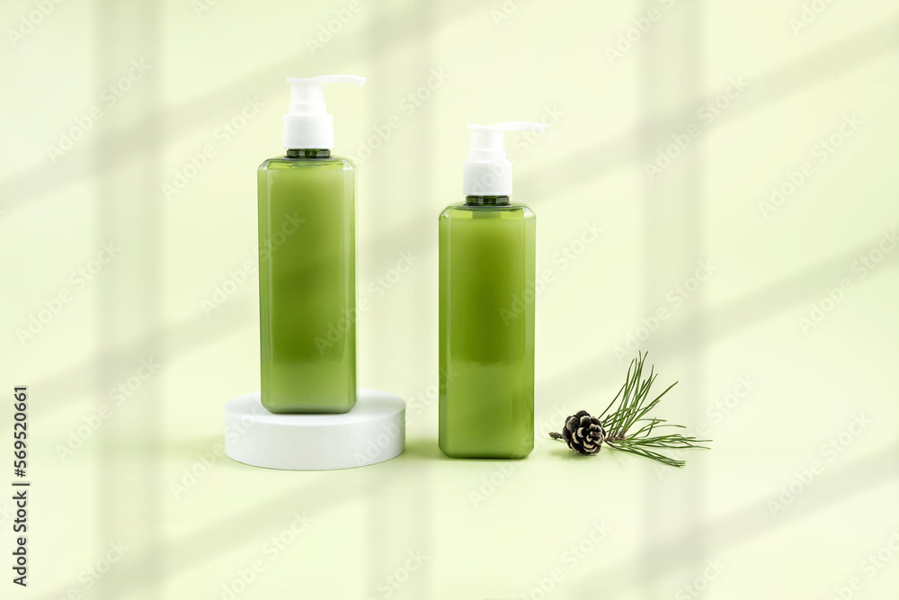 cosmetics containers on the podium, pine cone and pine branch on a light green background cosmetics containers on the podium, pine cone and pine branch on a light green background