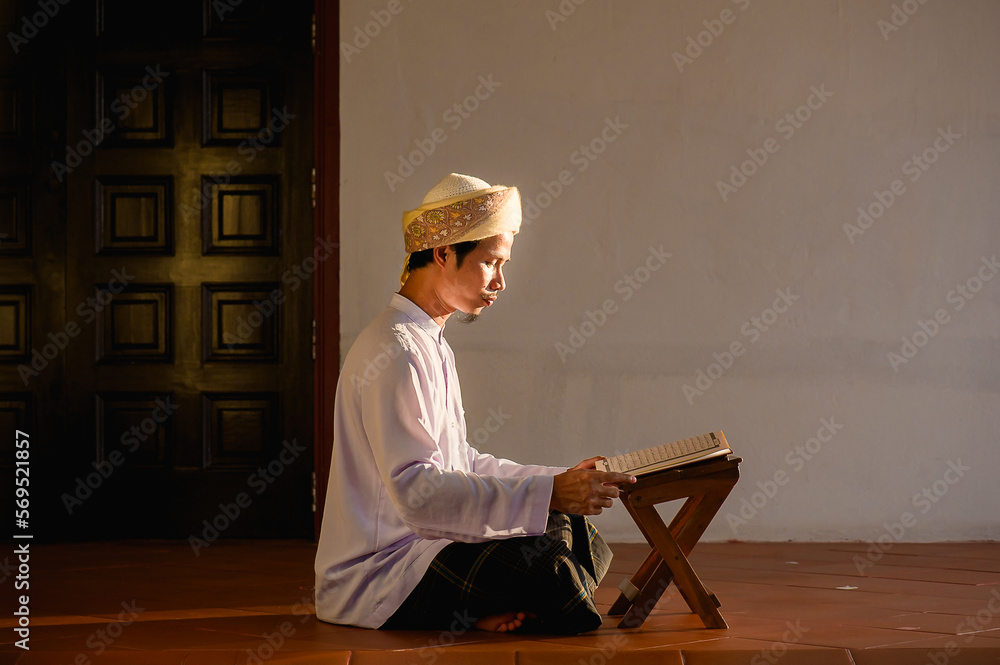 Religious muslim islam man in brown session sit on the floor and read