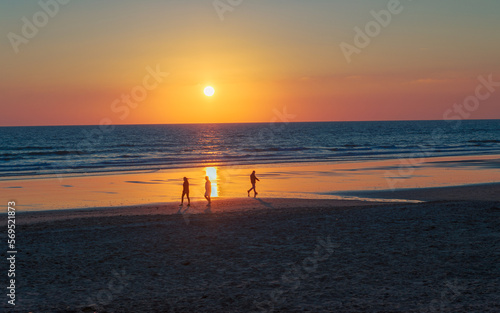 Silhouettes on the beach at sunset