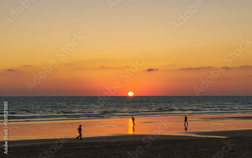 Silhouettes on the beach at sunset