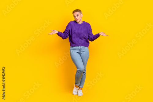 Full size photo of gorgeous optimistic positive woman with short hair violet sweater shrug shoulders isolated on yellow color background