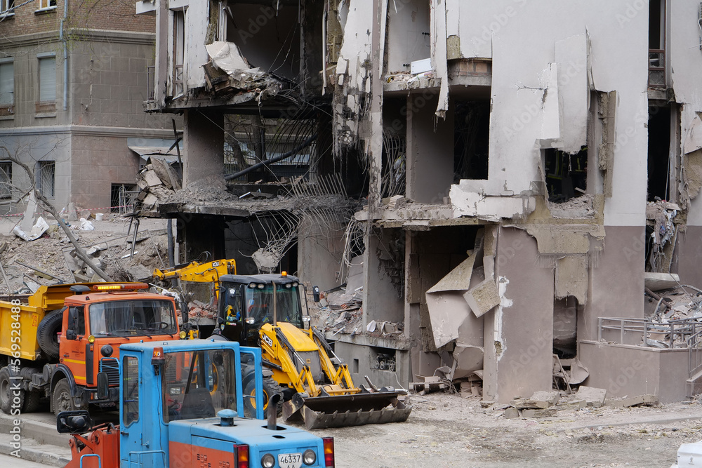 Workers clear rubble after bombing. Dwelling house damaged by russian missile Workers clear rubble after bombing. Dwelling house damaged by russian missile