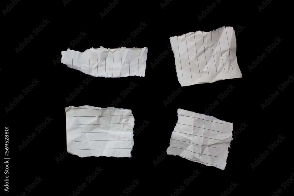 Torn crumpled lined paper piece isolated on black background Torn crumpled lined paper piece isolated on black background