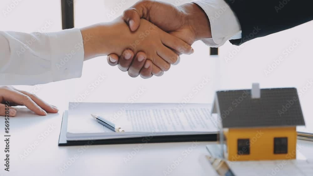 Real estate broker agent presenting and consult to customer to decision making sign insurance form agreement, buy and sell home model, concerning mortgage loan offer for and house insurance Real estate broker agent presenting and consult to customer to decision making sign insurance form agreement, buy and sell home model, concerning mortgage loan offer for and house insurance