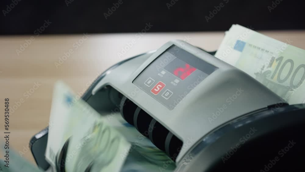 Automatic counting euro bills by bank machine close up. Calculating currency. Automatic counting euro bills by bank machine close up. Calculating currency.