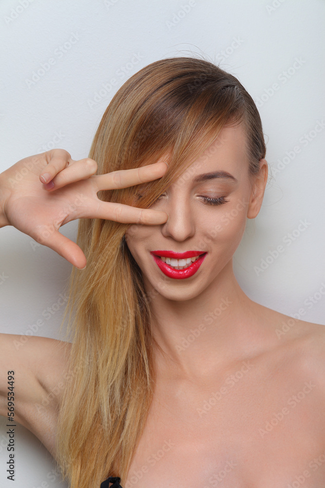 portrait of young woman with fingers to her eyes portrait of young woman with fingers to her eyes