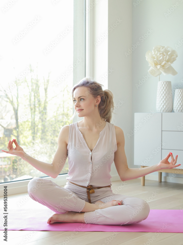Young beautiful woman practicing yoga pose in home Young beautiful woman practicing yoga pose in home
