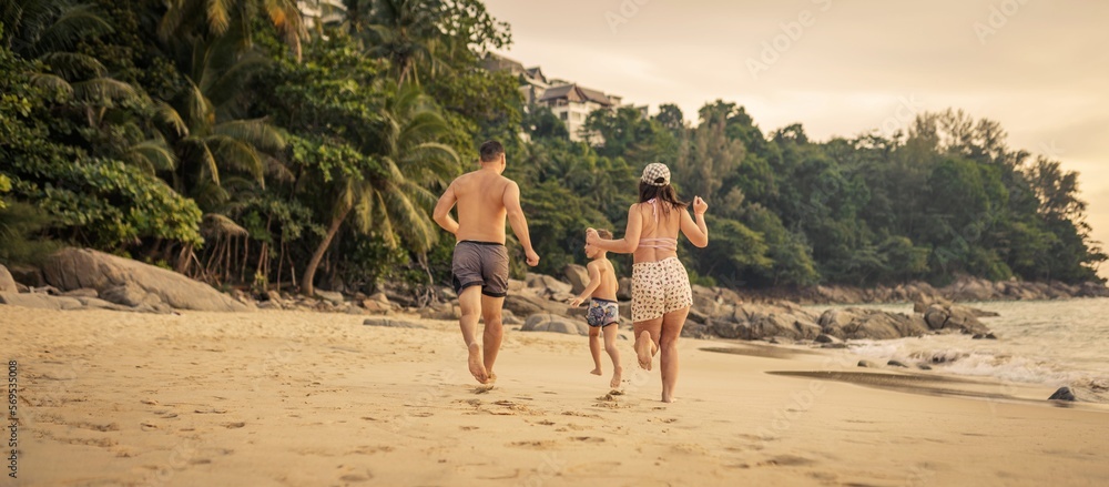 Family running on the beach 