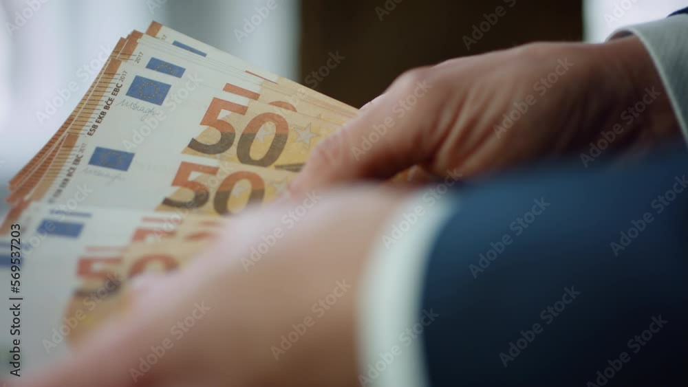 Fingers holding euro banknotes close up. Man counting european currency bills. Fingers holding euro banknotes close up. Man counting european currency bills.