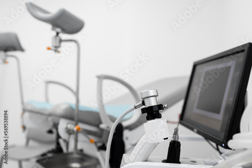 anoscope in the colonoscopy room against the background of a chair and a monitor on a white background with space for text. proctologist