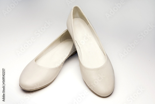 Women's leather shoes without heels, beige color, on white background
