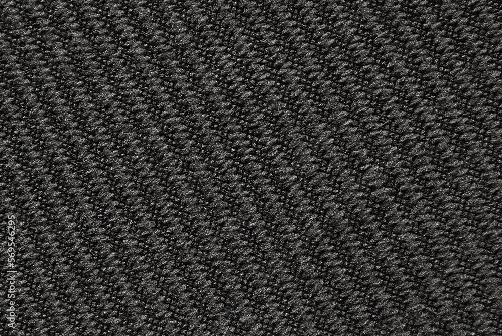 Soft dark gray ribbed fabric pattern close up as background Soft dark gray ribbed fabric pattern close up as background