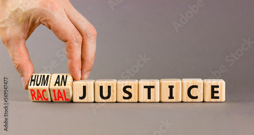 Racial or human justice symbol. Concept words Racial justice Human justice on wooden cubes. Beautiful grey background. Businessman hand. Ecological racial or human justice concept. Copy space.