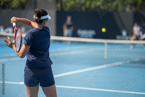 female Professional athlete Tennis player playing on a court in a tennis tournament in summer in australia photo