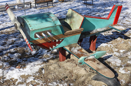 Airplane toy at the playground in winter time photo