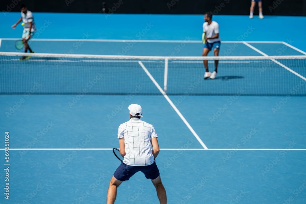 Fototapeta premium Amateur playing tennis at a tournament and match on grass in Melbourne, Australia