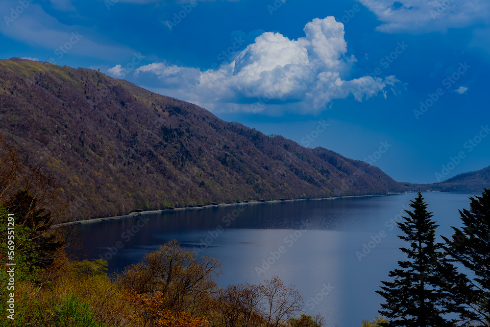 遠くから見た湖と山の稜線と青空