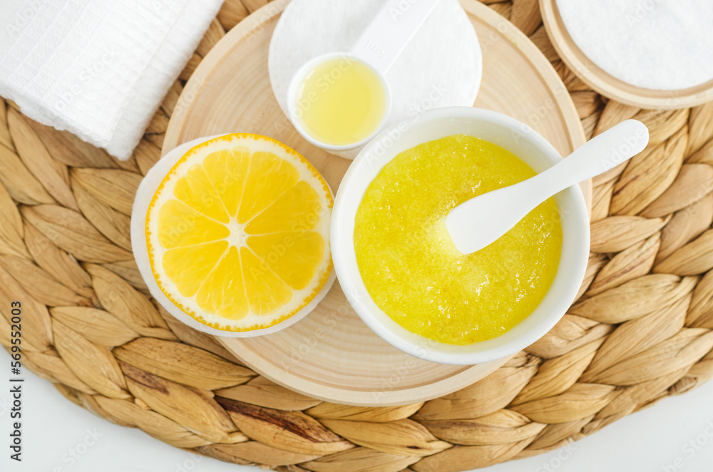 Homemade lemon sugar scrub in a small white bowl. Natural beauty treatment and spa recipe. Top view, copy space. Homemade lemon sugar scrub in a small white bowl. Natural beauty treatment and spa recipe. Top view, copy space.